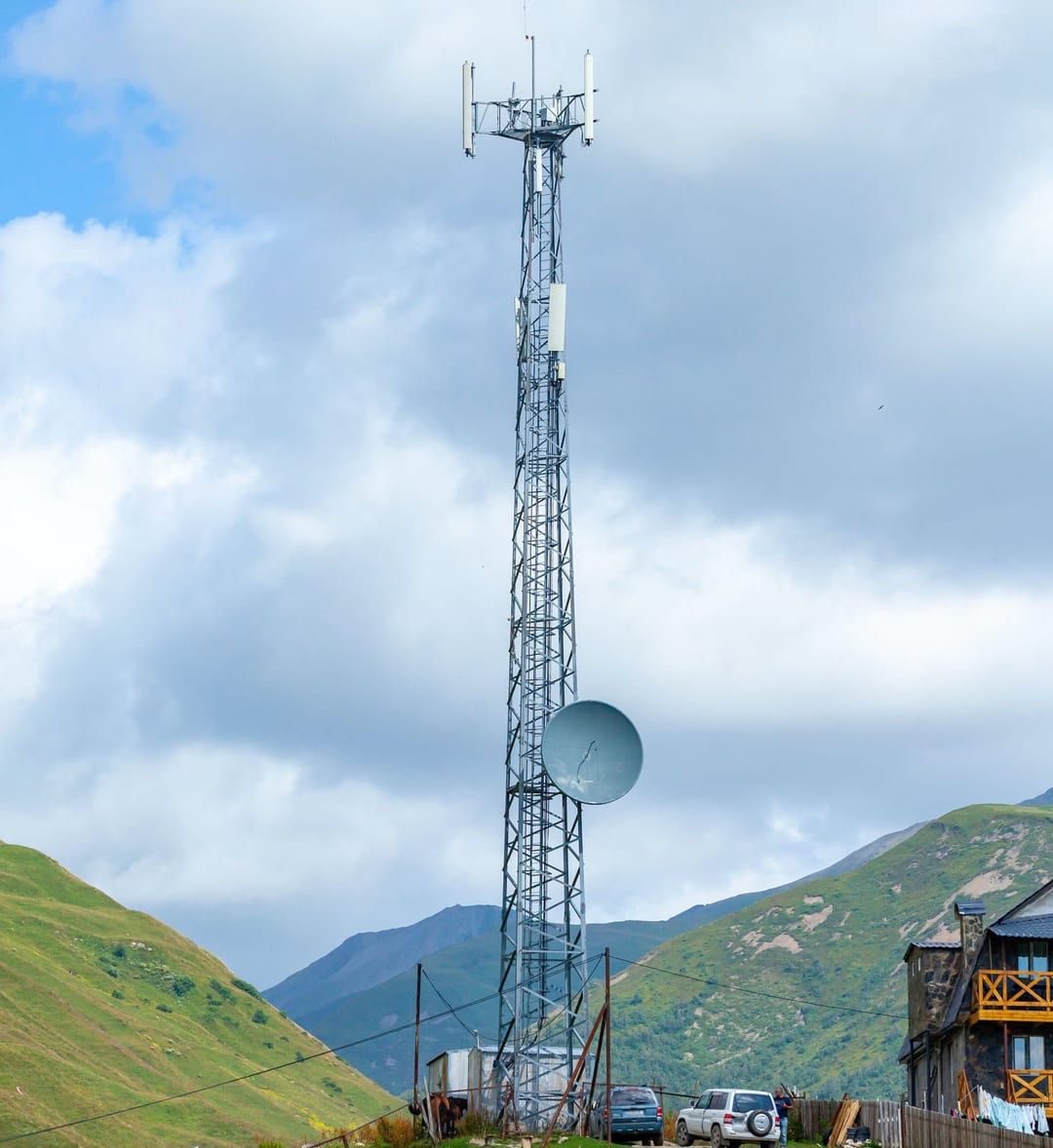 Cell tower against blue cloudy sky